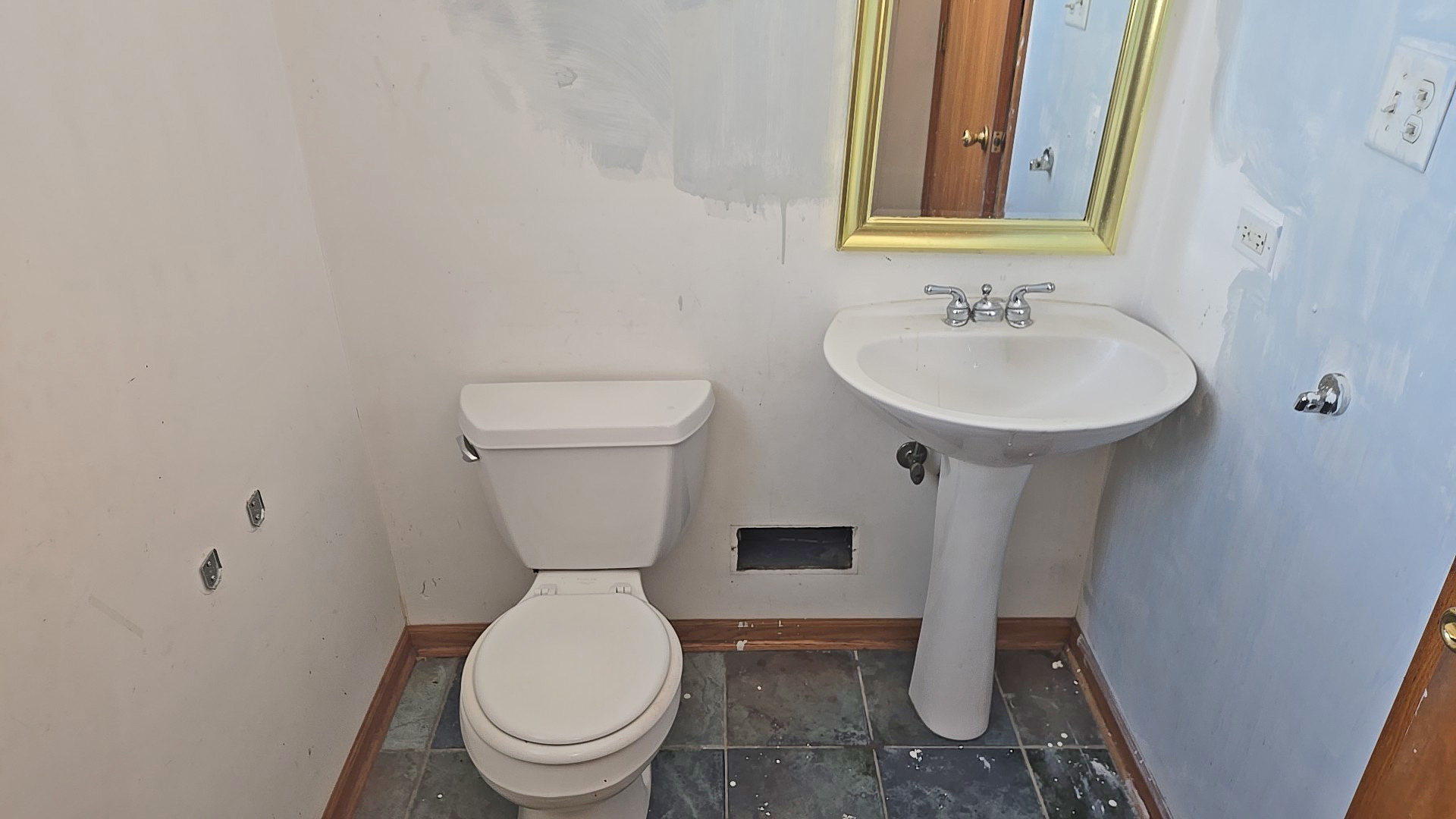 3417 Butler Avenue Steger, IL 60475 - Photo 17 of 22 a white toilet sitting next to a bathroom sink