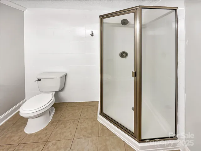 a bathroom with a toilet and a shower