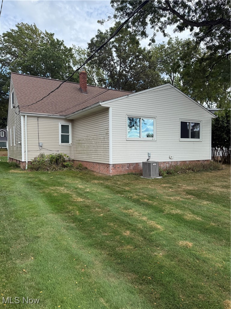 1284 Haverston Road Lyndhurst, OH 44124 - Photo 3 of 43 View of side of property featuring a yard, a chimney, roof with shingles, and crawl space