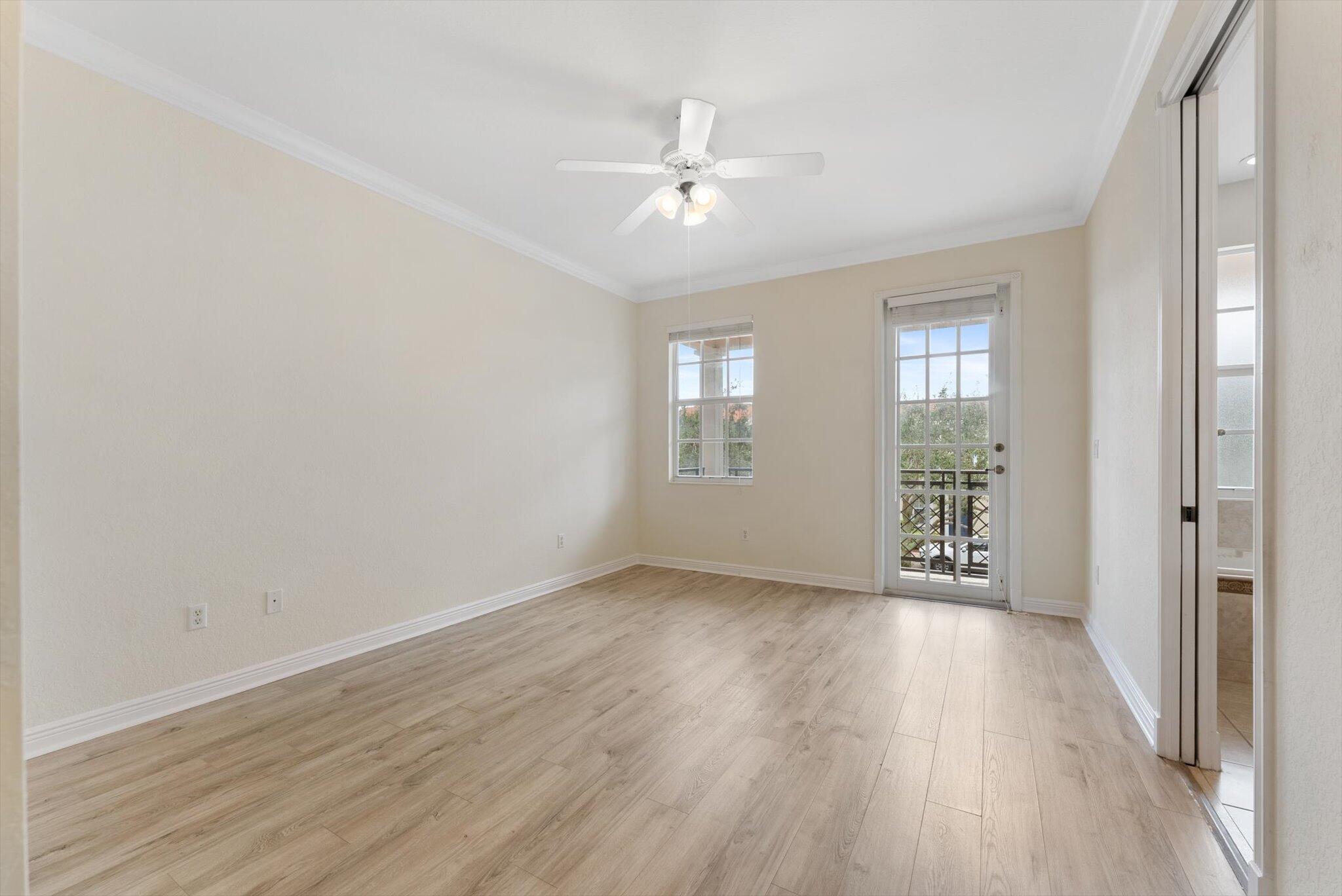 806 Northwest 83rd Lane Boca Raton, FL 33487 - Photo 12 of 37 a view of an empty room with wooden floor and a window