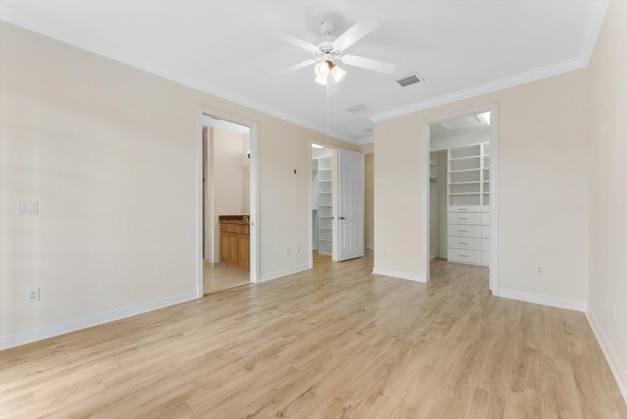 806 Northwest 83rd Lane Boca Raton, FL 33487 - Photo 14 of 37 wooden floor in an empty room with a ceiling fan