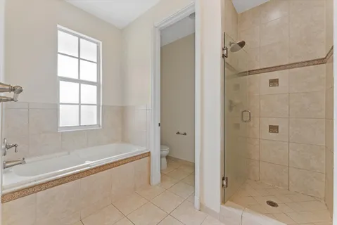 a spacious bathroom with a bathtub and shower