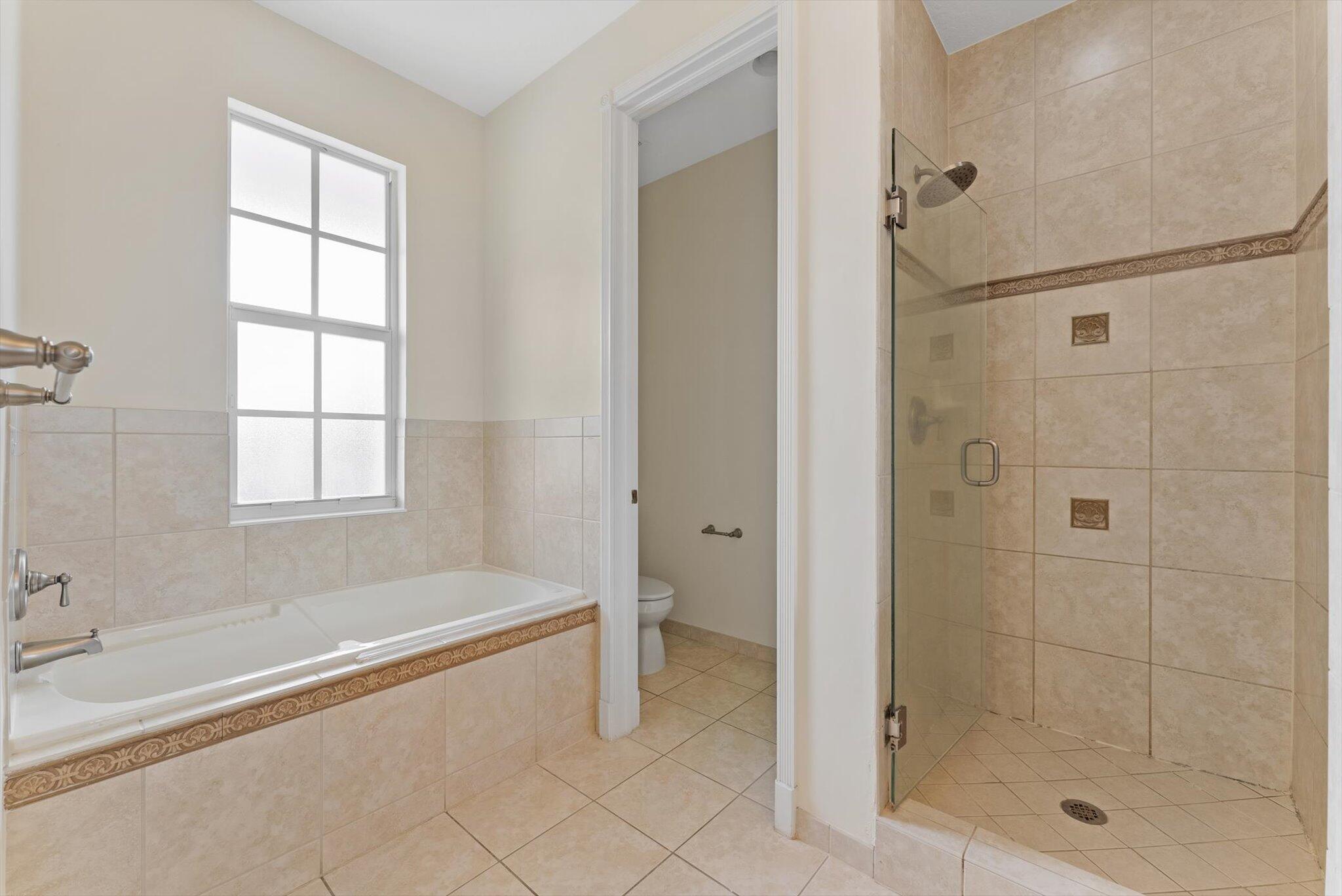 806 Northwest 83rd Lane Boca Raton, FL 33487 - Photo 16 of 37 a spacious bathroom with a bathtub and shower