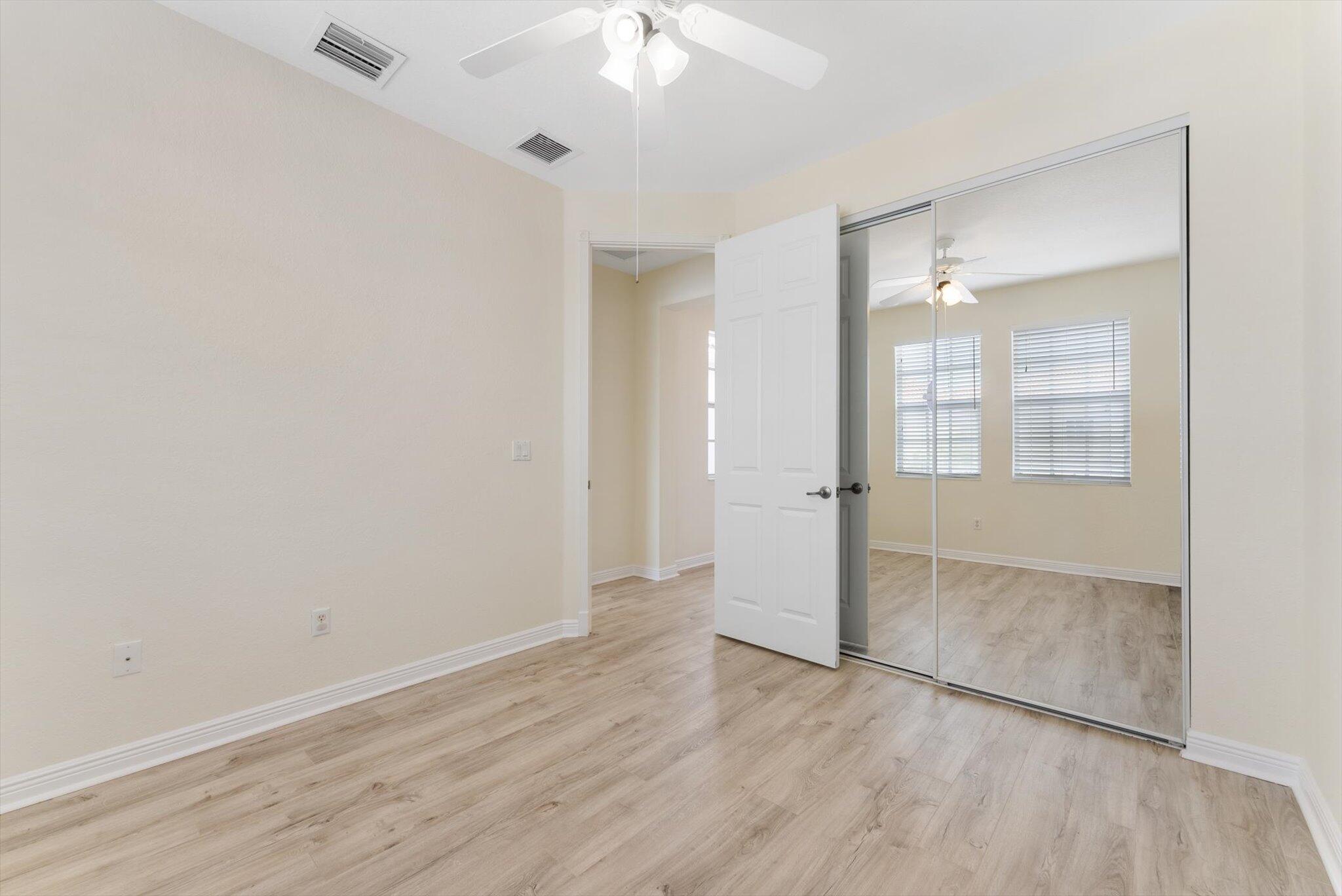 806 Northwest 83rd Lane Boca Raton, FL 33487 - Photo 19 of 37 wooden floor in an empty room with a window