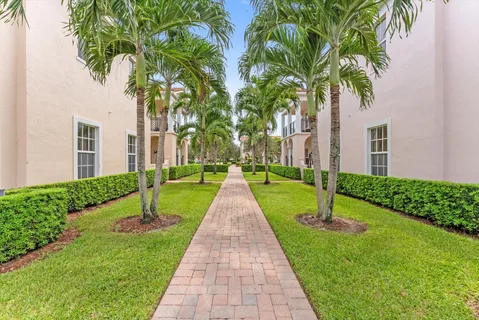 a front view of a house with a garden and yard