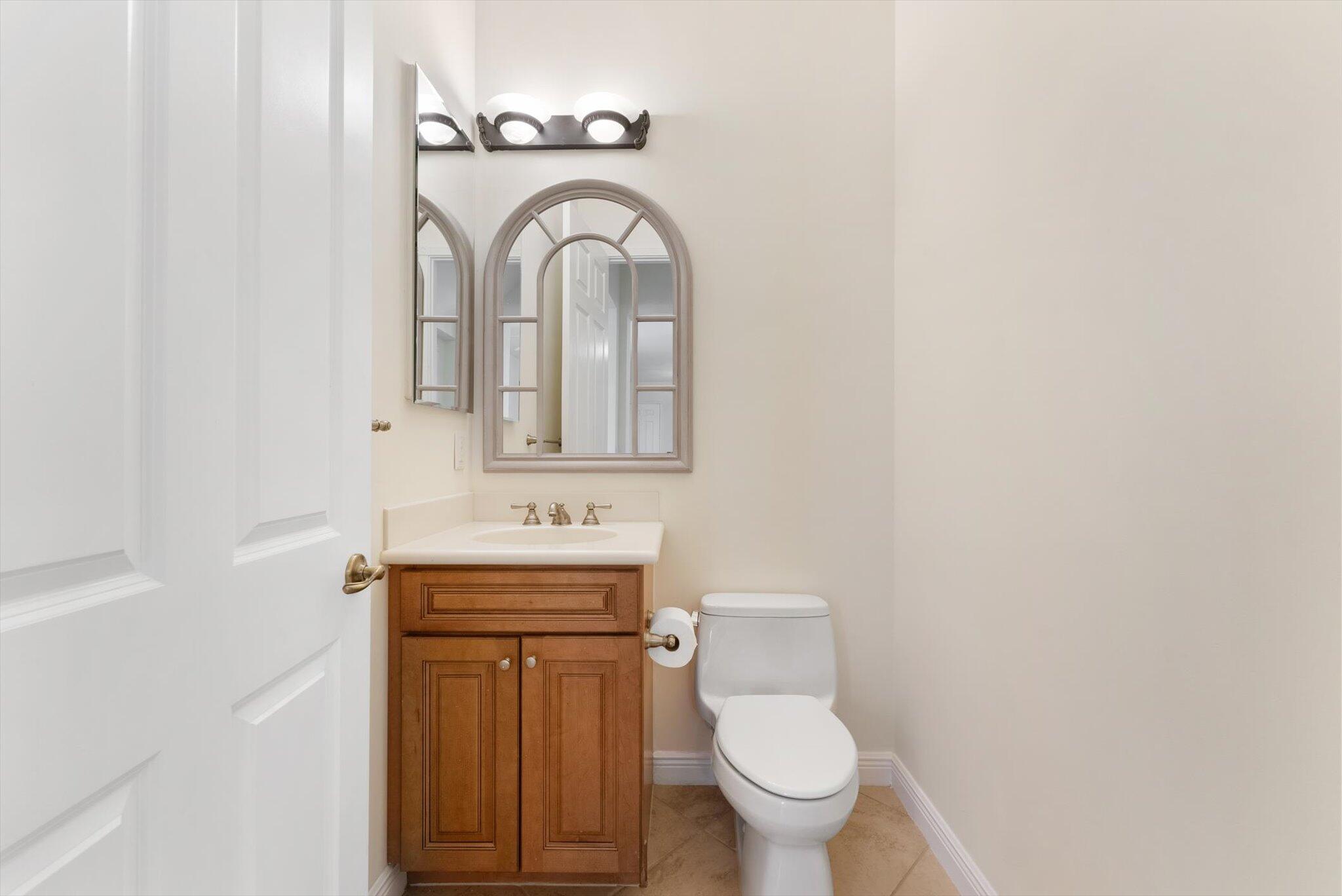 806 Northwest 83rd Lane Boca Raton, FL 33487 - Photo 7 of 37 a bathroom with a sink a toilet and mirror