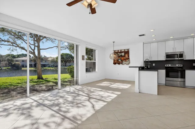 a living room with furniture and a floor to ceiling window