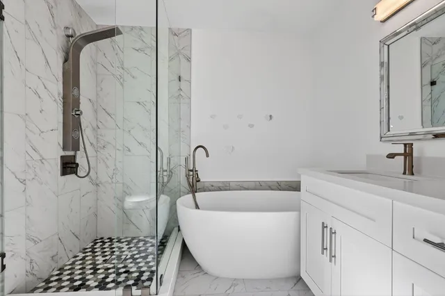 an empty room with chandelier fan and windows