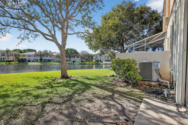 an aerial view of residential houses with outdoor space and lake view