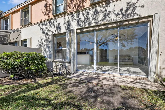 an aerial view of ocean and residential houses with outdoor space