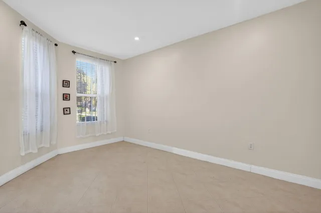 a view of staircase with white walls and a window