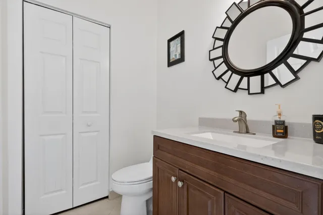 a bathroom with a toilet a sink and a mirror