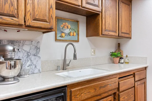 a kitchen with stainless steel appliances granite countertop a sink a stove and a refrigerator