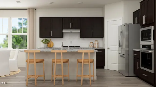 a kitchen with stainless steel appliances a stove a sink and a refrigerator