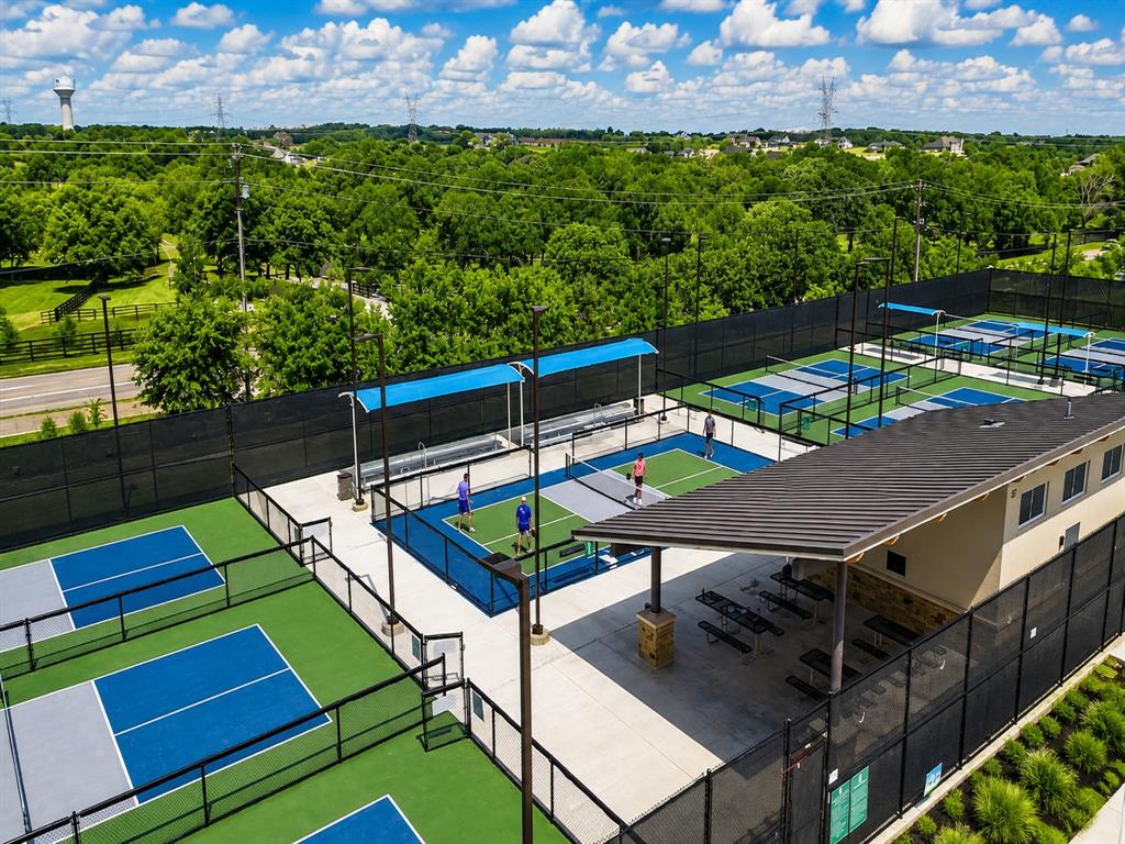 920 Sheldon Road Argyle, TX 76226 - Photo 36 of 36 Premier Tennis and Pickleball Court Complex with Multiple Championship-Caliber Playing Surfaces, Professional-Grade Netting and Fencing, Covered Spectator Areas with Shade Structures, and Manicured Grounds Overlooking Mature Landscaping and Established Tree Line