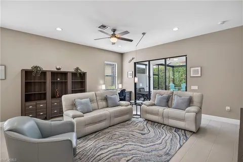 a living room with furniture and ceiling fan