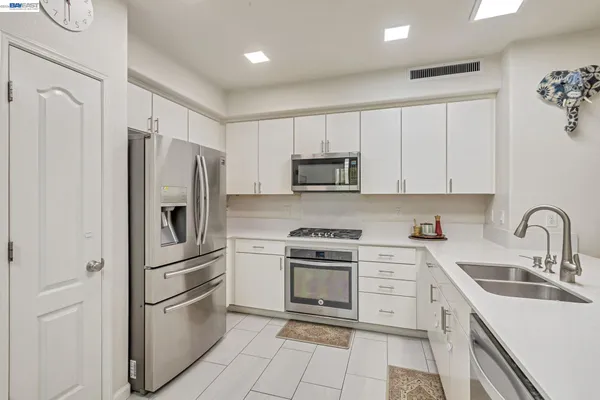a kitchen with cabinets and stainless steel appliances