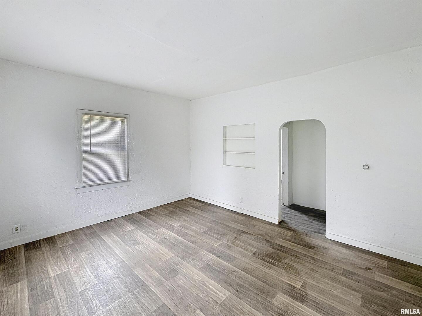 204 Main Avenue Matherville, IL 61263 - Photo 8 of 27 an empty room with wooden floor and windows