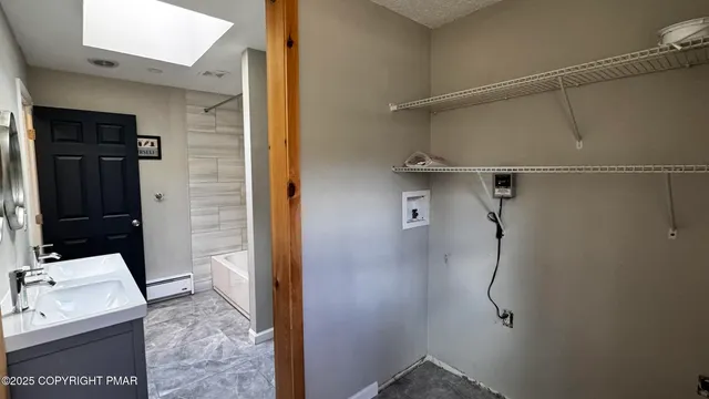 a view of a room with rack on the wall and a window