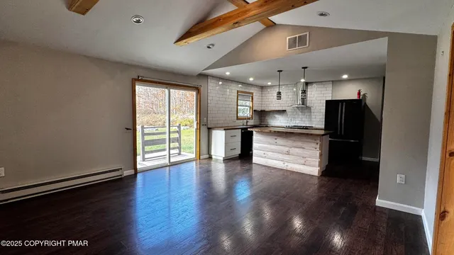 a kitchen with stainless steel appliances granite countertop wooden cabinets a sink and a stove