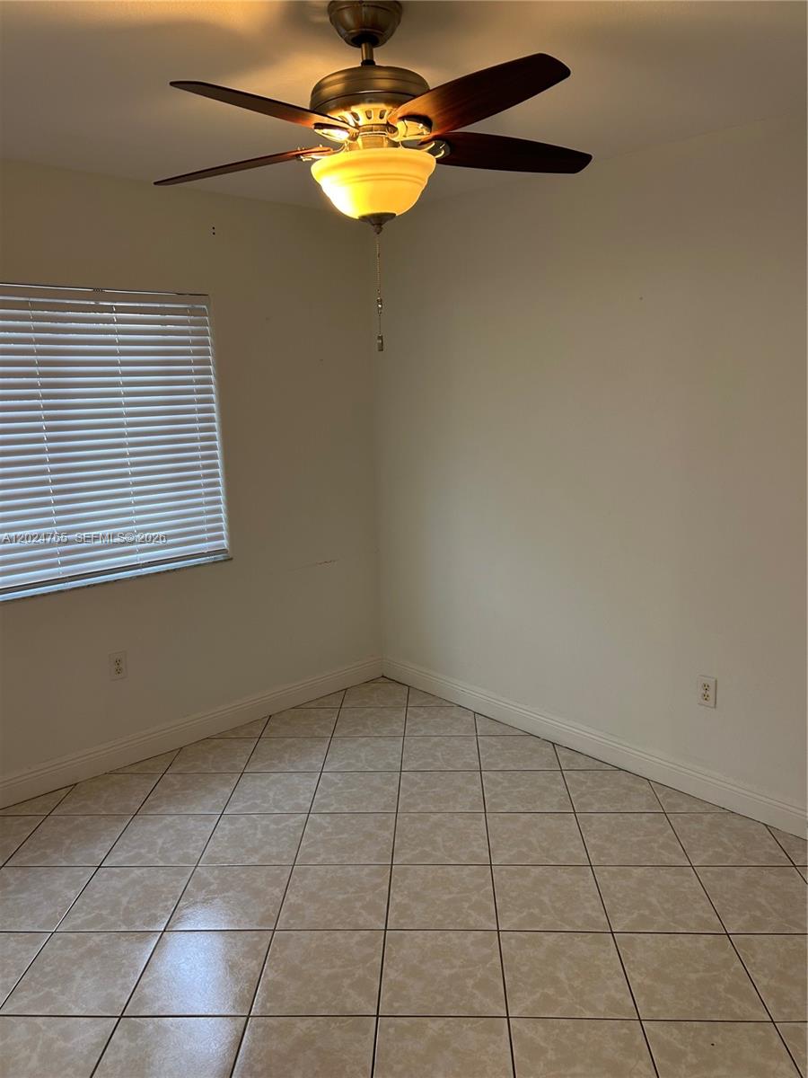 10919 West Okeechobee Road, Unit 101 Hialeah Gardens, FL 33018 - Photo 19 of 21 a view of an empty room with a window