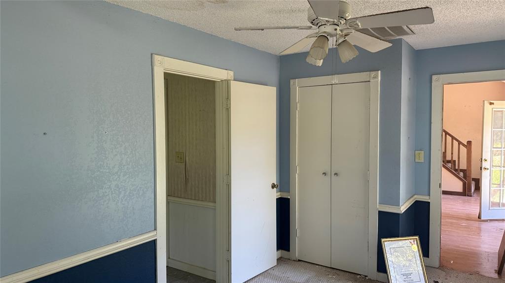 6582 Taylor Road Kaufman, TX 75142 - Photo 32 of 40 a view of a hallway with a chandelier fan and wooden floor