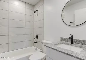 a bathroom with a sink a toilet and a mirror
