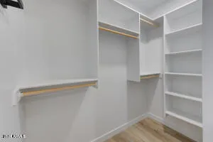 a view of walk in closet with empty racks