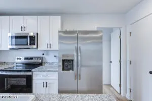 a kitchen with cabinets and stainless steel appliances