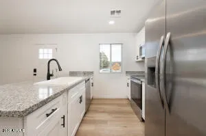 a kitchen with stainless steel appliances granite countertop a sink stove and refrigerator
