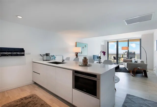 a view of living room filled with furniture and wooden floor