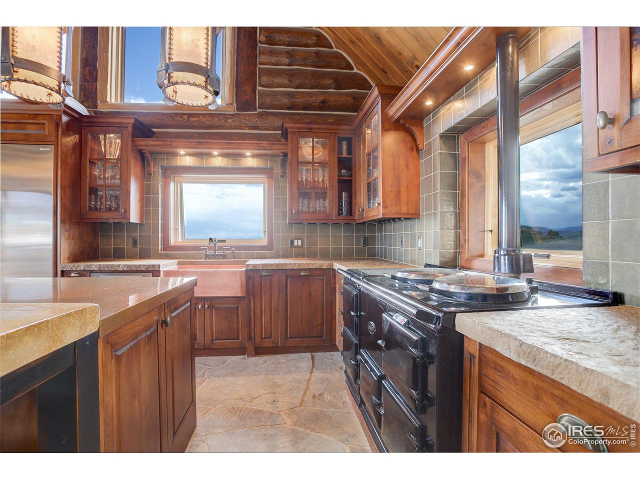 9126 Gold Mine Road Fort Collins, CO 80526 - Photo 11 of 40 a kitchen with a stove a sink and a refrigerator