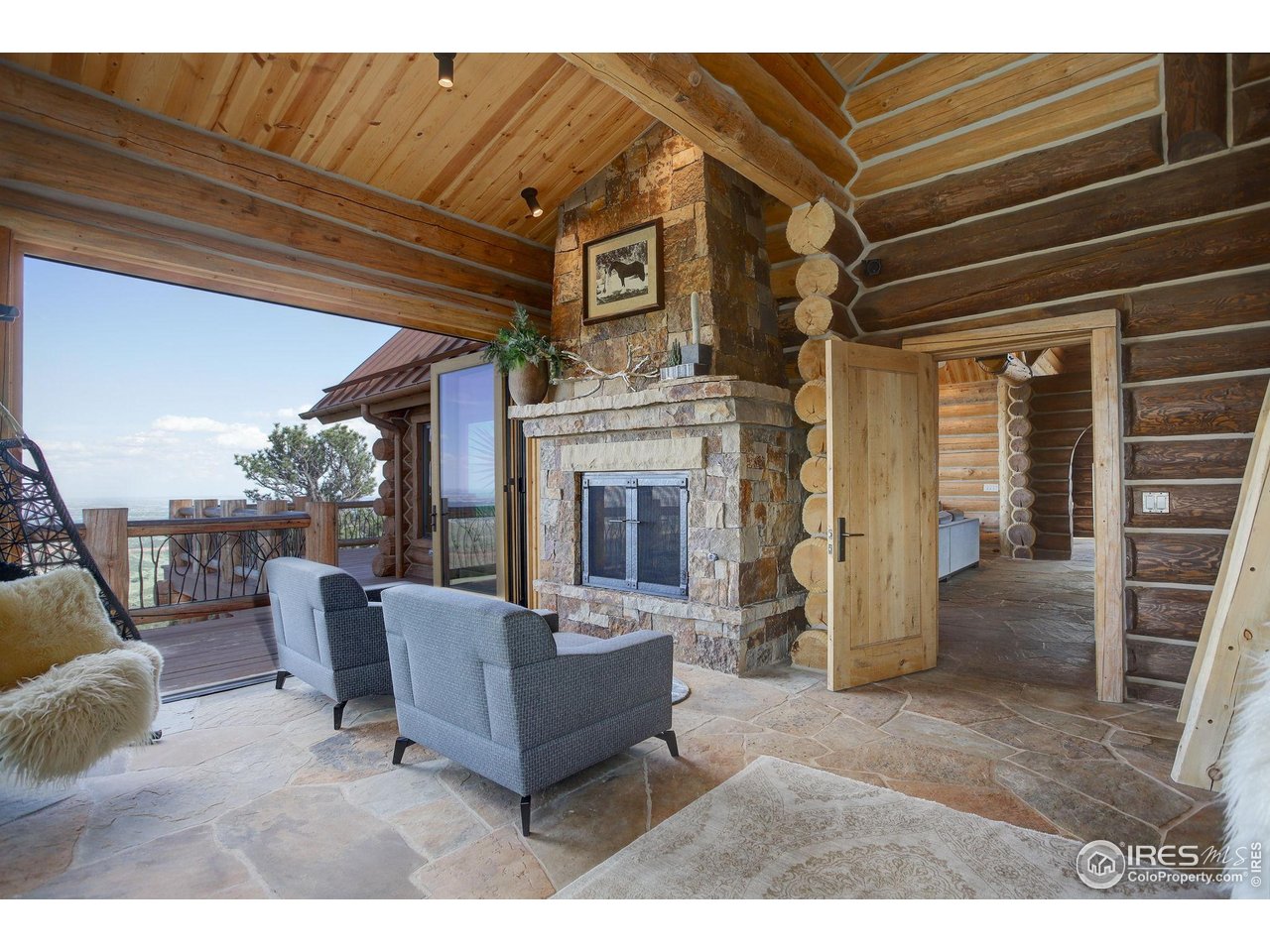 9126 Gold Mine Road Fort Collins, CO 80526 - Photo 18 of 40 a living room with furniture and a fireplace