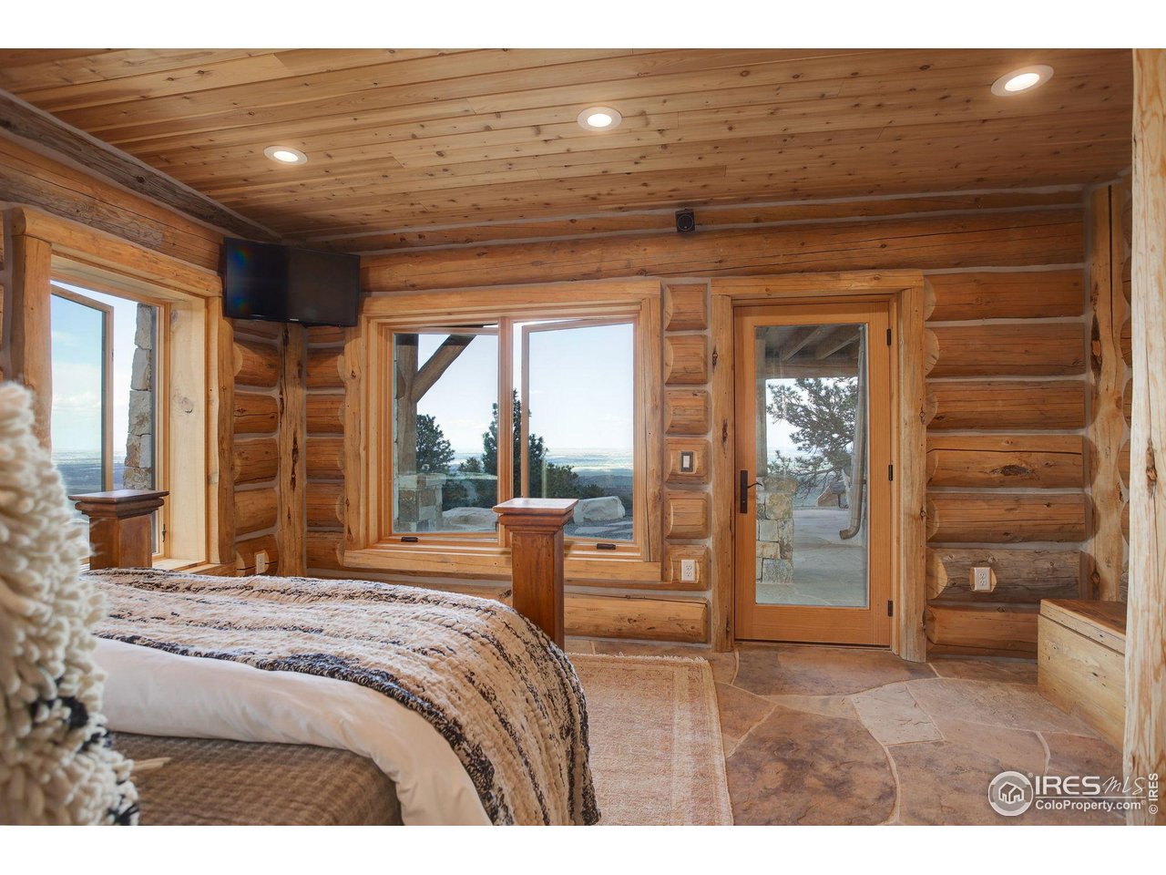 9126 Gold Mine Road Fort Collins, CO 80526 - Photo 24 of 40 a bedroom with a bed and a large window