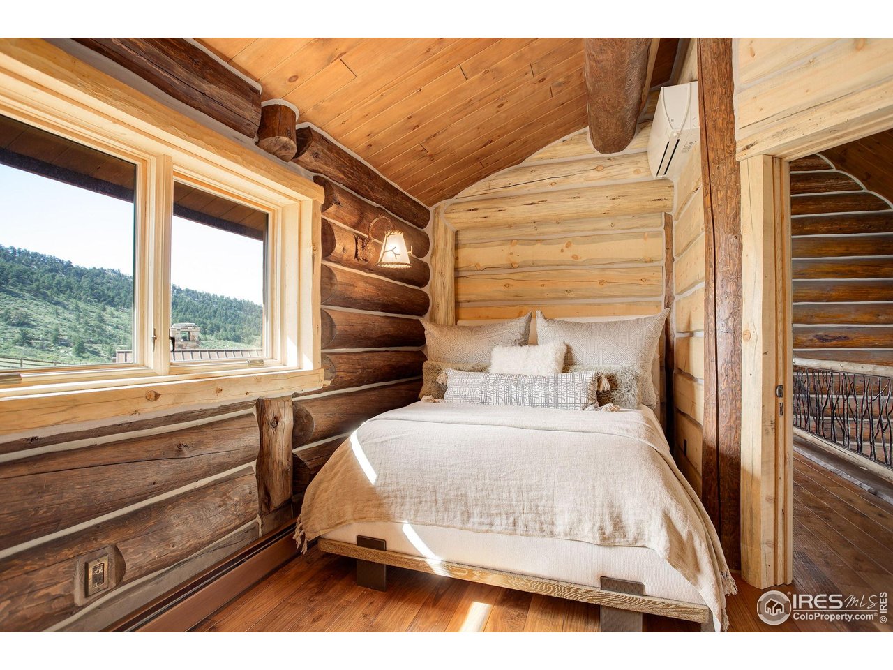 9126 Gold Mine Road Fort Collins, CO 80526 - Photo 26 of 40 a bedroom with a bed and a large window