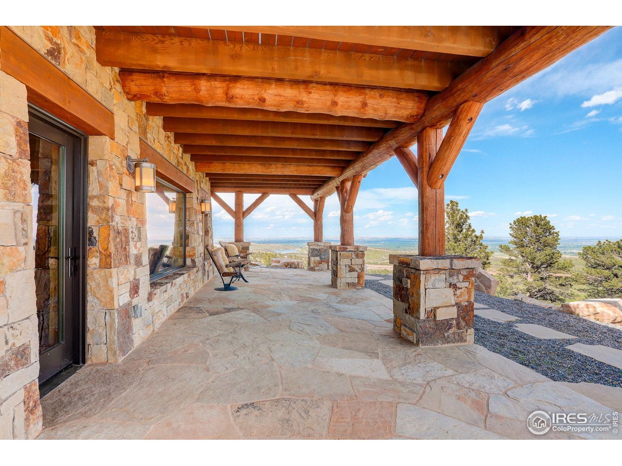 9126 Gold Mine Road Fort Collins, CO 80526 - Photo 28 of 40 a view of a porch with furniture and a yard