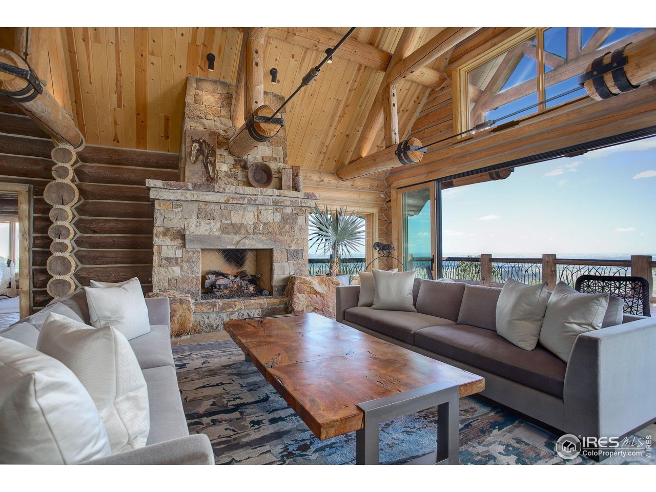 9126 Gold Mine Road Fort Collins, CO 80526 - Photo 4 of 40 a living room with furniture a fireplace and a table