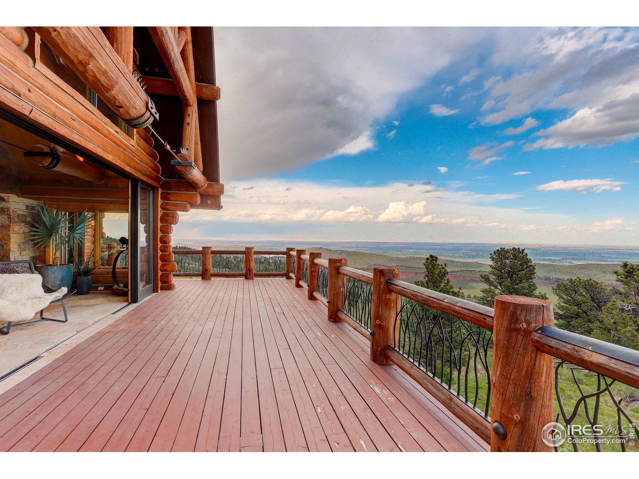 9126 Gold Mine Road Fort Collins, CO 80526 - Photo 7 of 40 a view of a balcony with wooden floor and outdoor seating