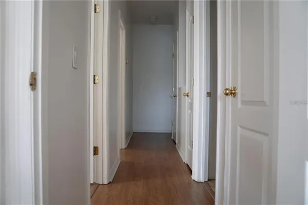 a view of a hallway with wooden floor