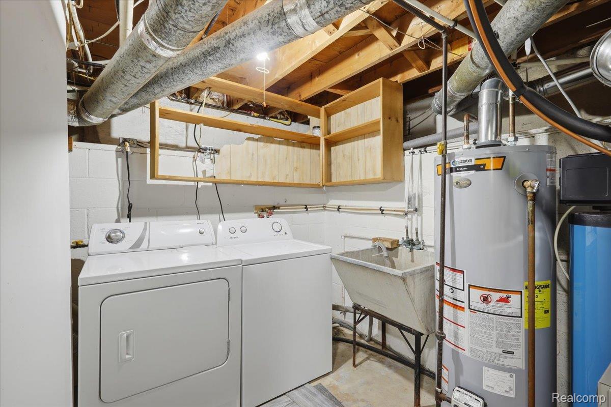 5307 Drayton Road Clarkston, MI 48346 - Photo 29 of 46 Dedicated utility area featuring a water heater, laundry sink, and overhead cabinetry