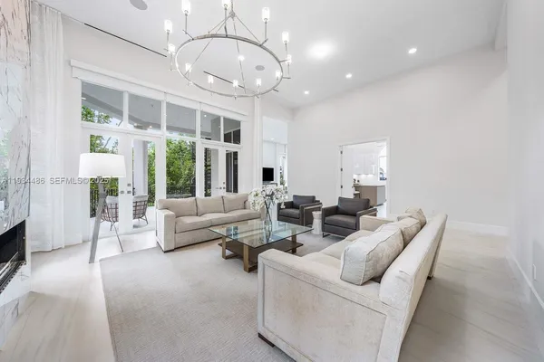 a large white room with a large window and flat screen tv