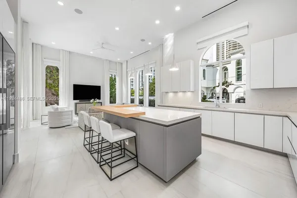 a kitchen with stainless steel appliances granite countertop a sink refrigerator and cabinets