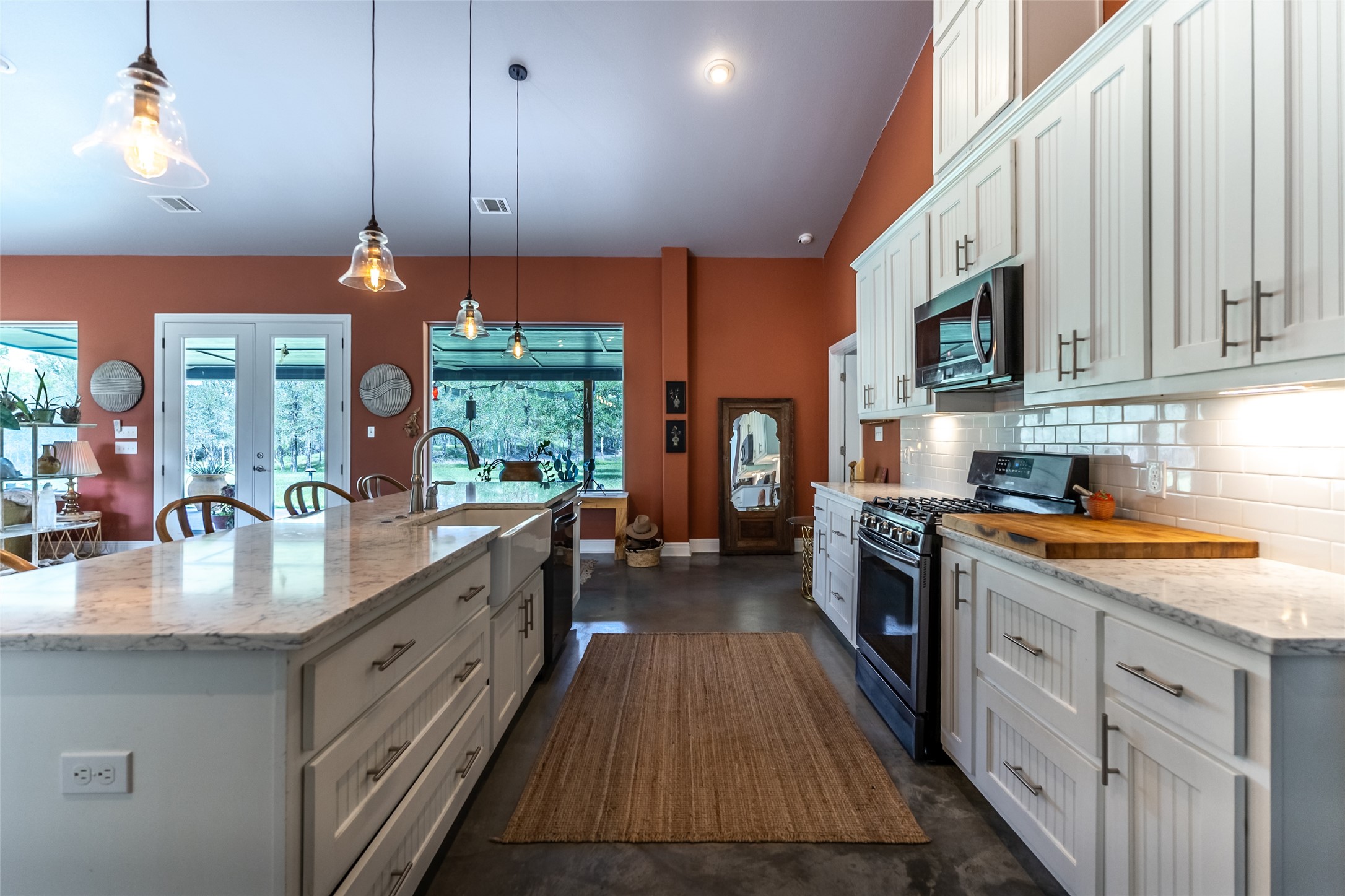 4082 Old Colony Line Road Lockhart, TX 78644 - Photo 4 of 40 An inviting kitchen with soaring vaulted ceilings and abundant natural light creates an airy atmosphere for culinary pursuits.