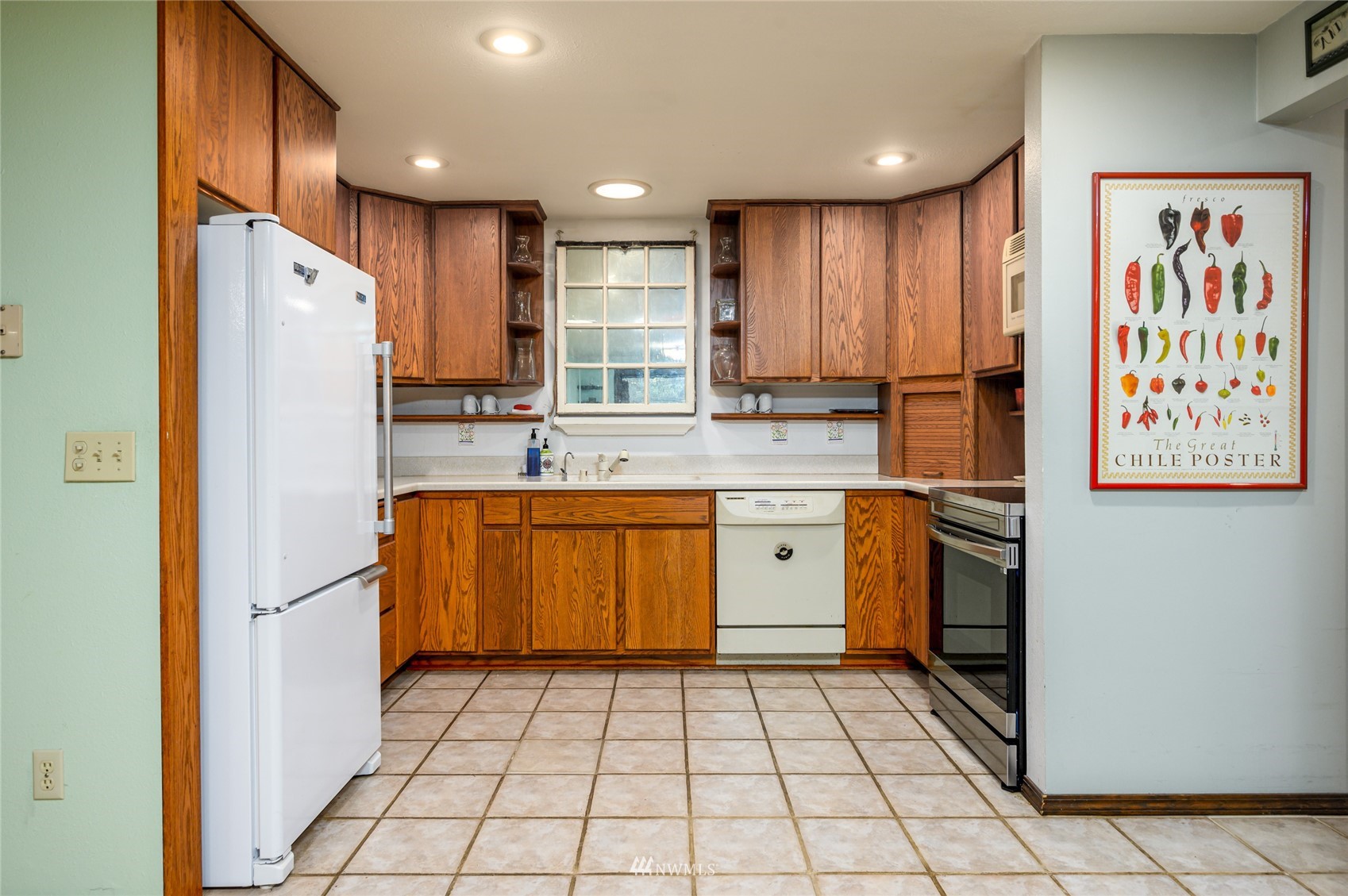 118 Sudden Valley Drive Bellingham, WA 98229 - Photo 9 of 35 a kitchen with a refrigerator a sink and cabinets