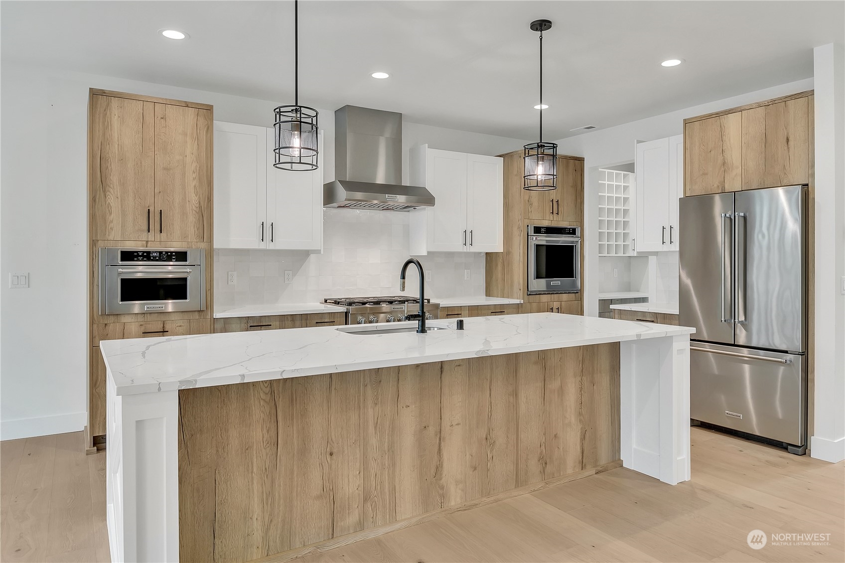 5425 Parker Road East Sumner, WA 98390 - Photo 12 of 40 a kitchen with stainless steel appliances granite countertop a sink a refrigerator and a refrigerator