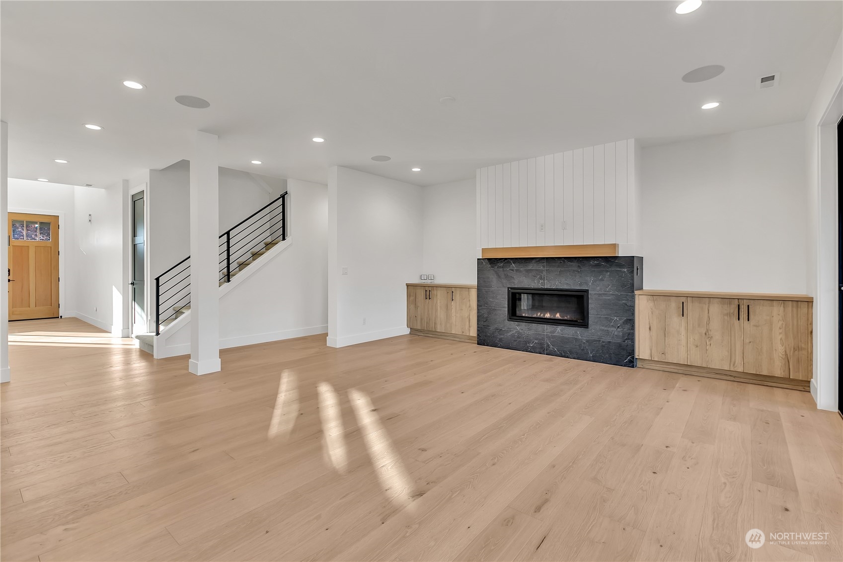 5425 Parker Road East Sumner, WA 98390 - Photo 18 of 40 a view of empty room with wooden floor and fireplace