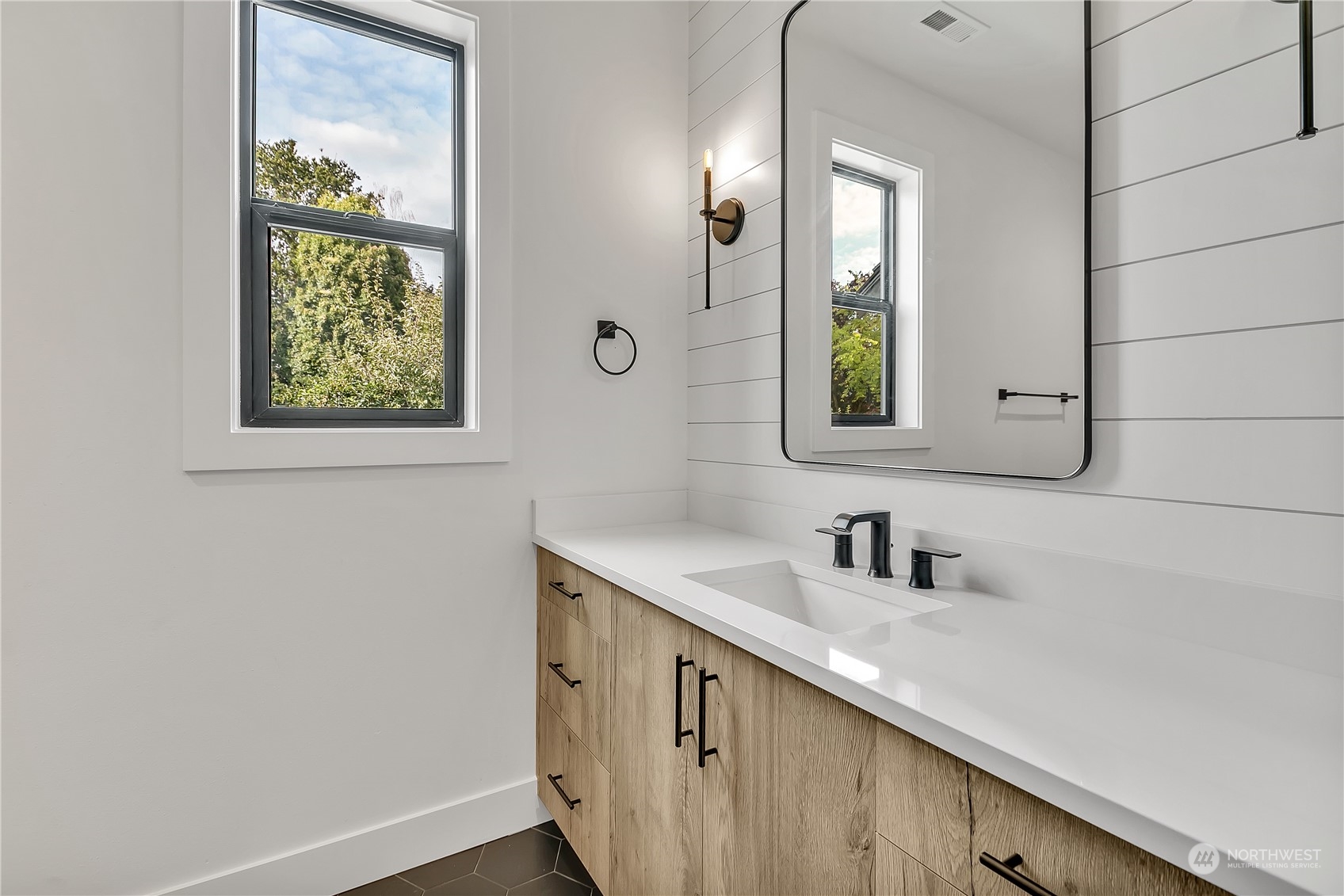 5425 Parker Road East Sumner, WA 98390 - Photo 23 of 40 a bathroom with a sink a mirror and next to a window