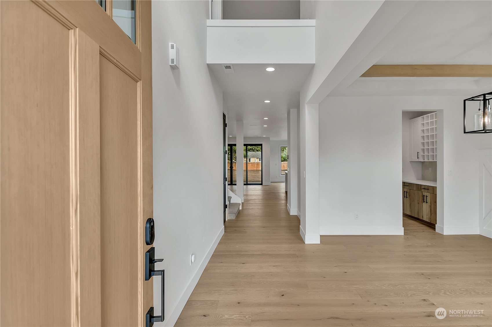 5425 Parker Road East Sumner, WA 98390 - Photo 7 of 40 a view of a hallway with wooden floor and a fireplace