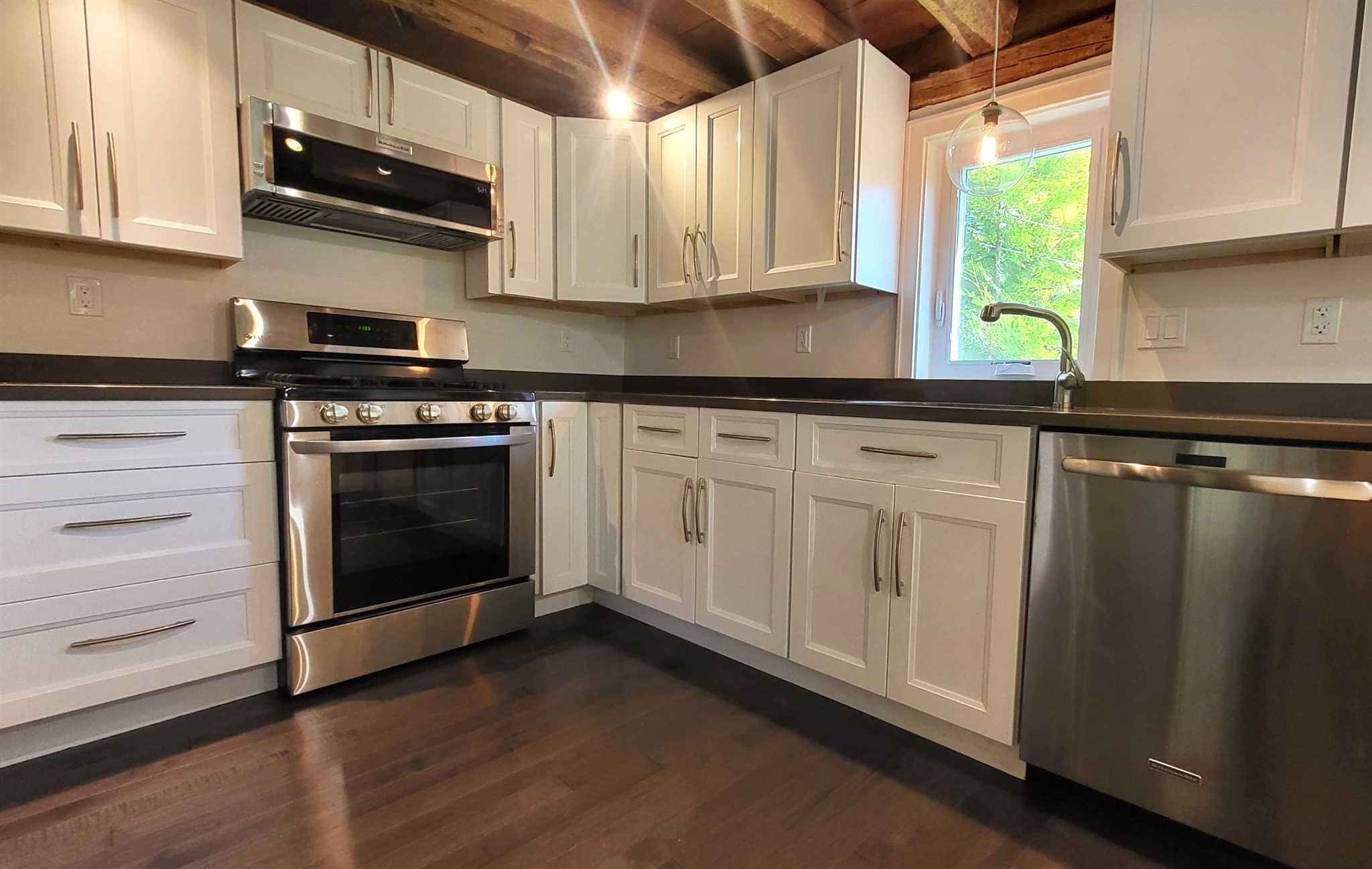 7 Looking Rocks Lane Hopewell Junction, NY 12533 - Photo 7 of 22 a kitchen with granite countertop white cabinets stainless steel appliances and a window