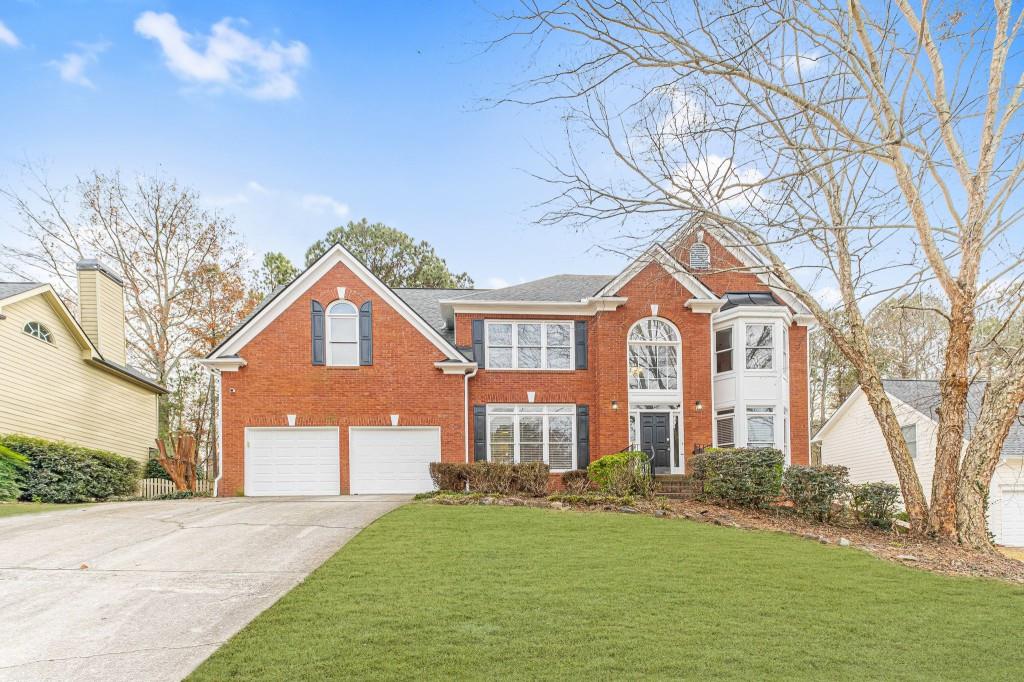 3403 Mill Grove Terrace Dacula, GA 30019 - Photo 1 of 1 a front view of a house with a garden and trees